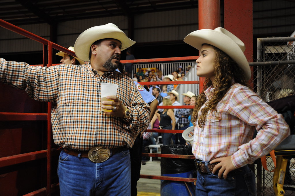 Rodeo arena event with mechanical bull entertainment and crowd participation